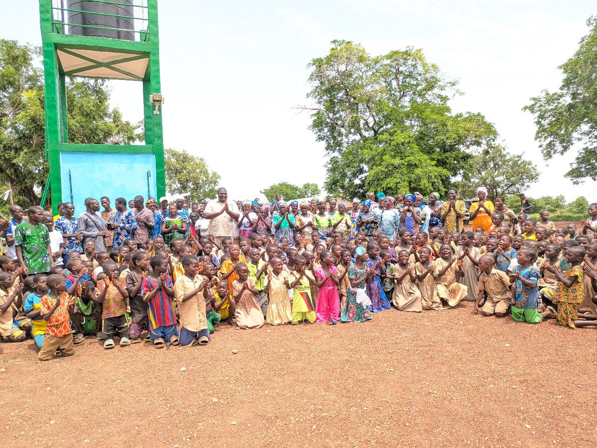 A village gathered around a newly dedicated Living Water well tower in Togo